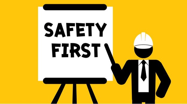 Safety first sign with worker in hard hat