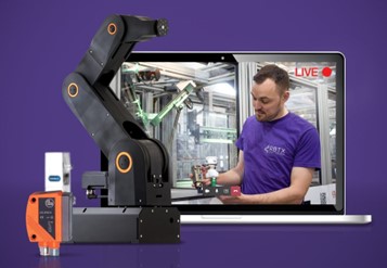 robotic arm, laptop and person working a delta robot