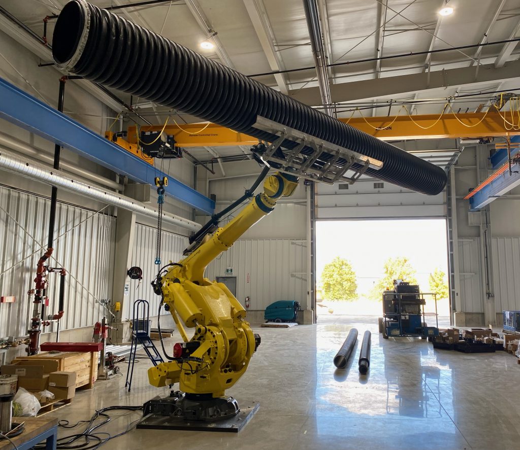 six-axis robot holding corrugated plastic pipe