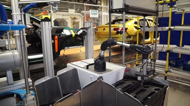 robotic arm in an automotive plant that does gluing automated