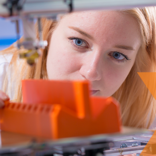 woman peering into 3d printing with plastics machine