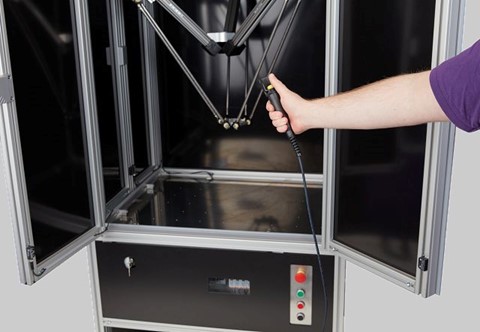 robotic cell with a delta robot and activating button