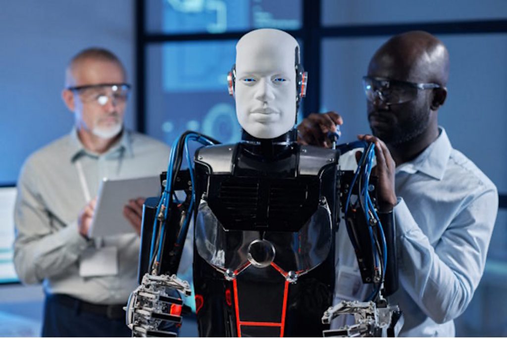 engineers performing maintenance on humanoid robot