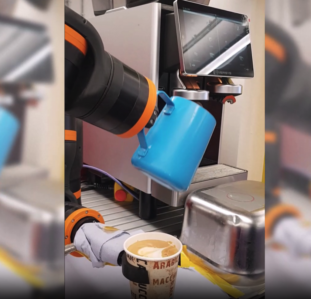 ReBeL cobot receiving coffee from dispenser into a cup it's holding
