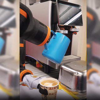 ReBeL cobot receiving coffee from dispenser into a cup it's holding