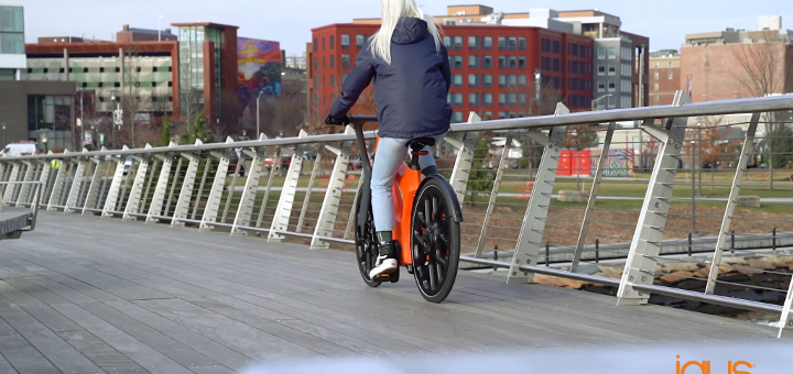 person on igus bike riding across a bridge