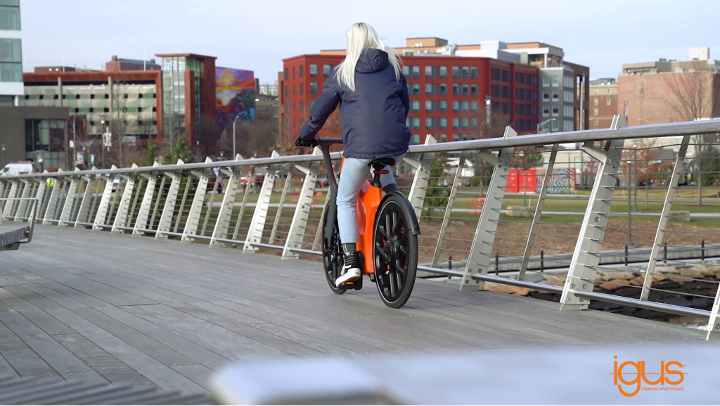 person on a bike across a bridge