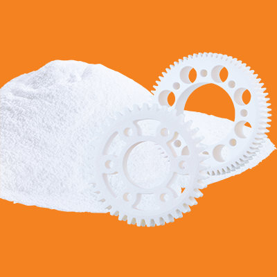 SLS powder and plastic gears in white on a background of igus orange