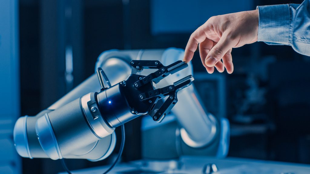 robot arm touching human finger