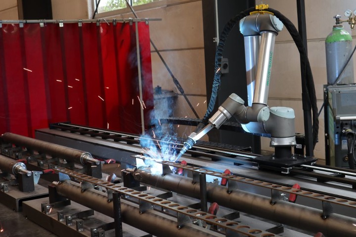 A robotic arm welding metal parts
