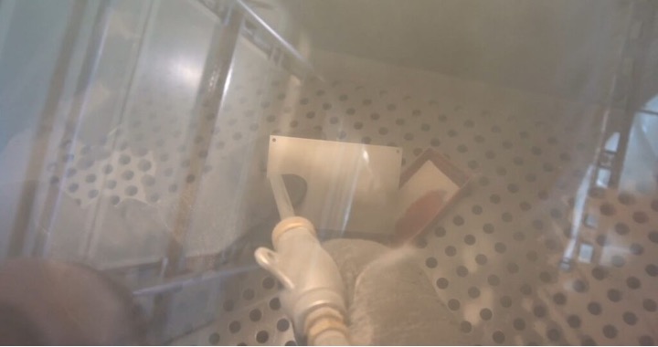powder coating a metal plate in an enclosed location
