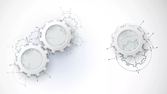 white plastic gears with technical diagrams in the background