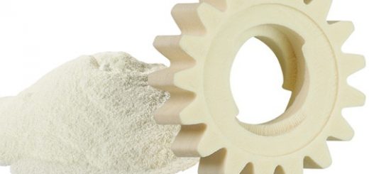 off-white 3D-printed plastic gear next to sls powder