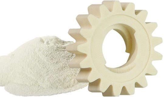 off-white 3D-printed plastic gear next to sls powder