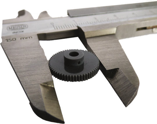 black plastic gear being measured with a caliper