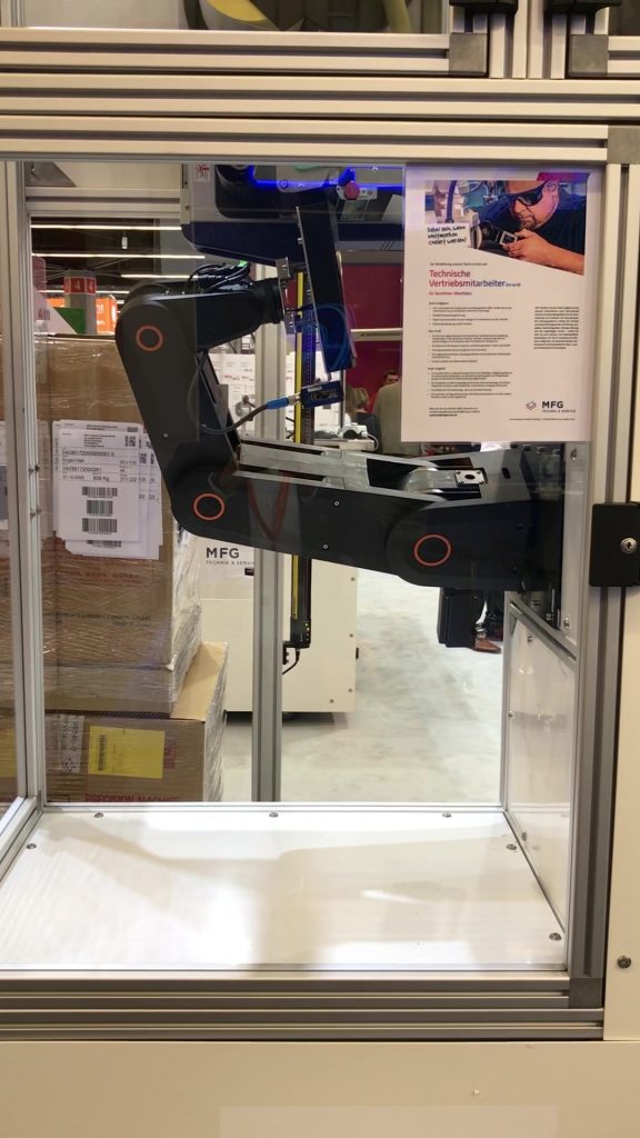 Robotic arm with end tool in enclosed glass case