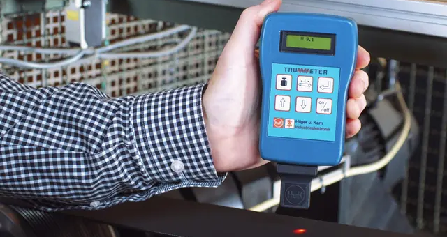 man holding belt tension meter