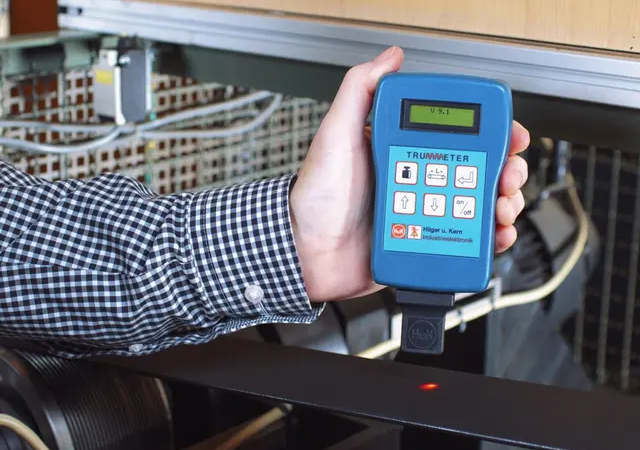 man holding belt tension meter